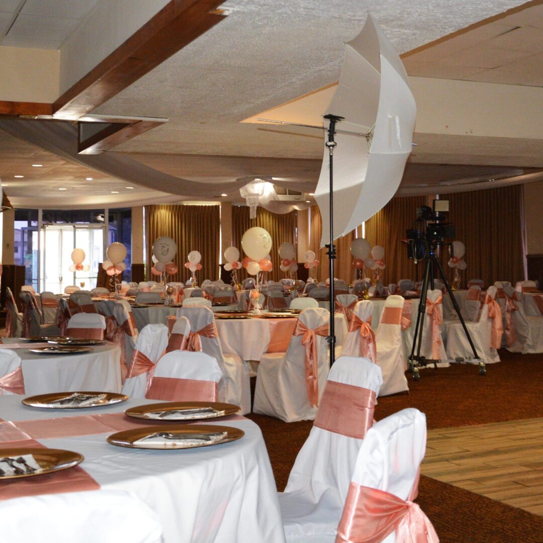 A banquet hall with tables and chairs set up for an event.