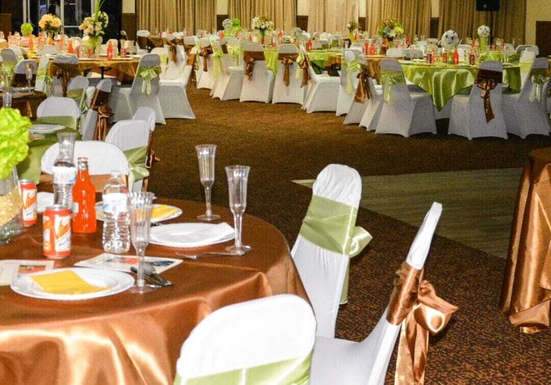 A banquet hall with tables and chairs set up for an event.